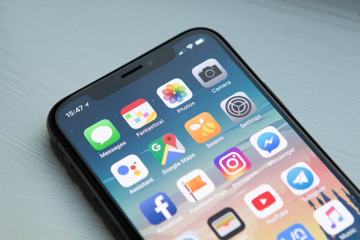 Hand holding a smartphone with a dating app on screen
